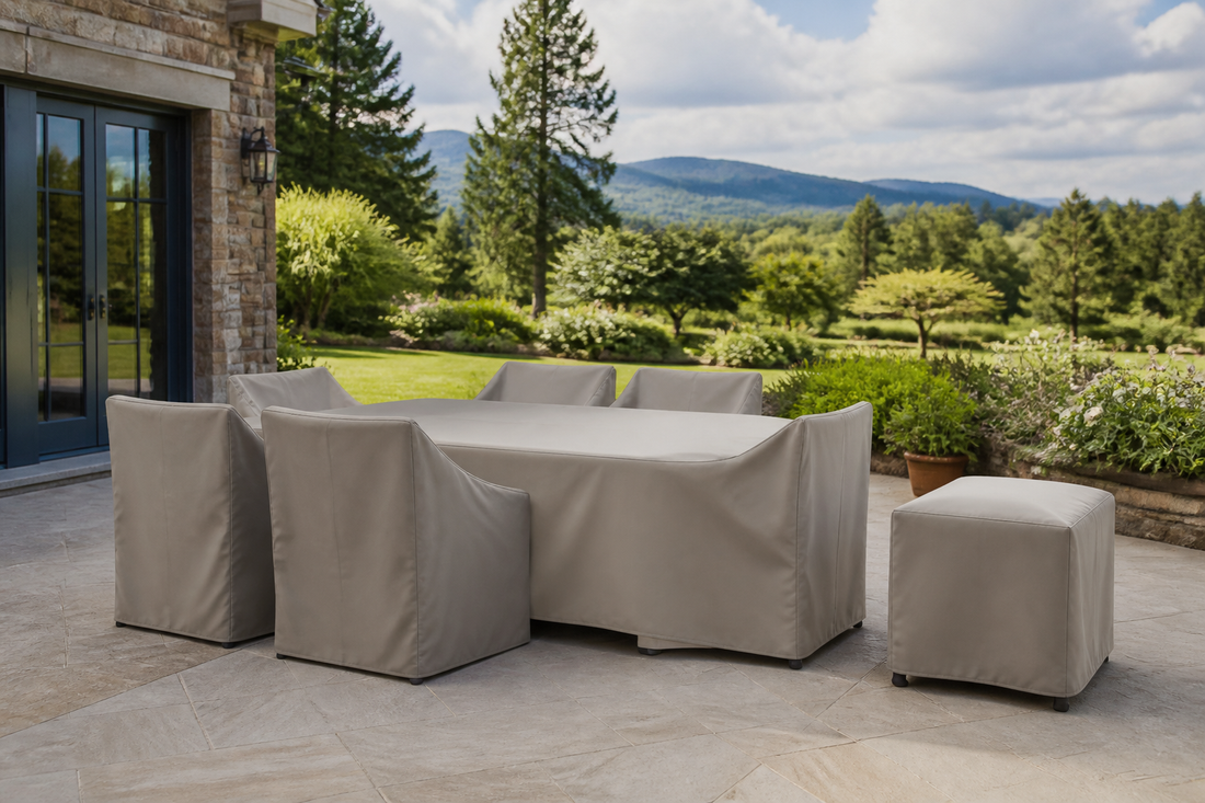 Outdoor dining table, chairs, and side table protected with fitted weather-resistant covers on a residential patio