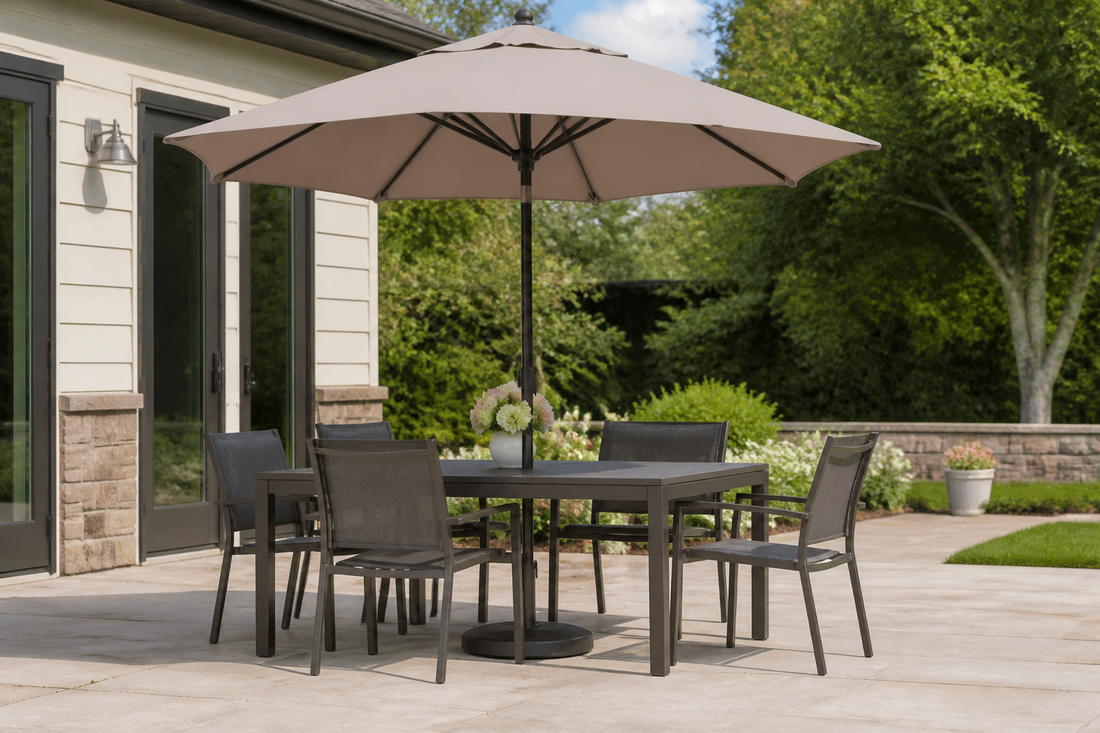 Outdoor dining table and chairs shaded by a patio umbrella with visible clearance around the canopy